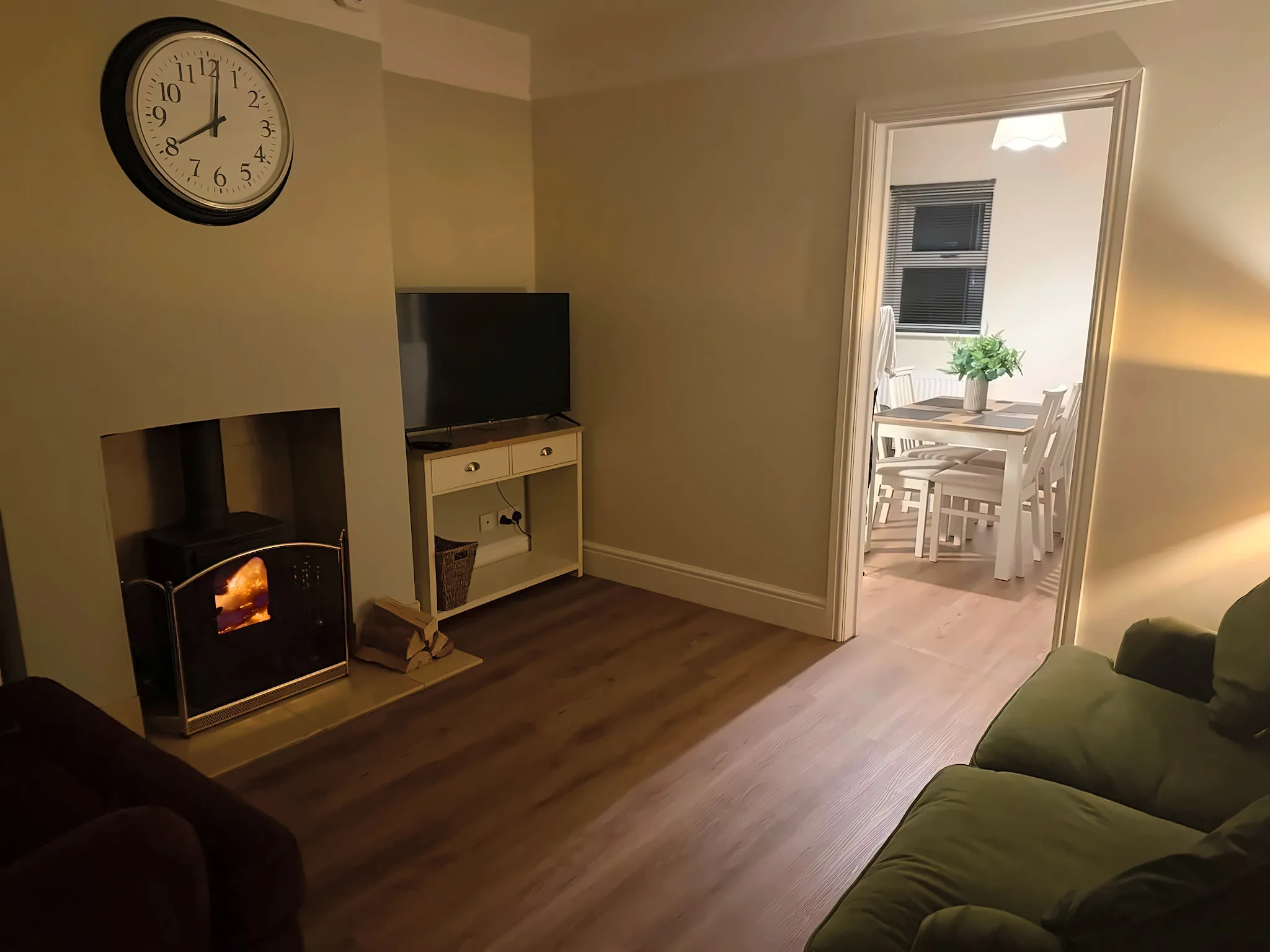 The sitting room in the evening, with the log burner lit
